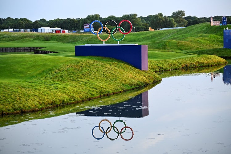 A water body with a pond and a blue wall with rings on it