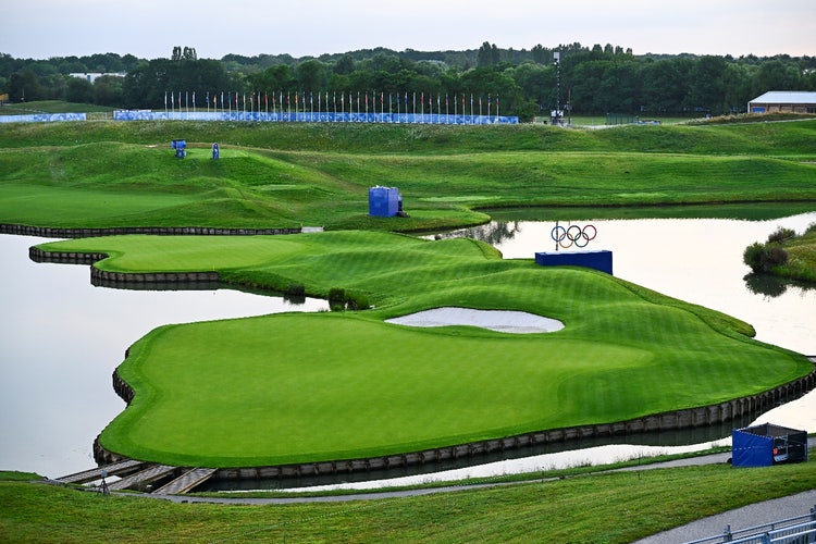 A golf course with water and a lake AI-generated content may be incorrect.