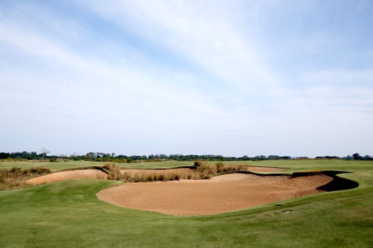 A golf course with sand trap Description automatically generated